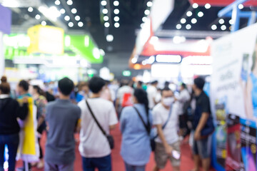 Abstract blur people in exhibition hall event trade show expo background. Business convention show, job fair, or stock market.