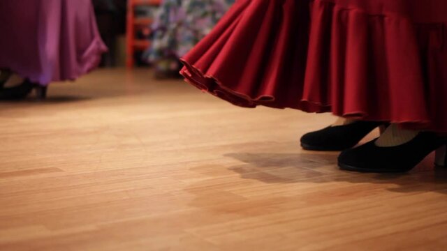 Flamenco dancers taking steps on a wooden stage in a Spanish restaurant in Japan.