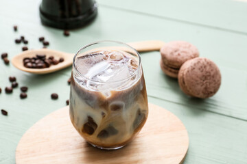 Glass of tasty iced coffee on table