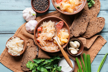 Composition with tasty sauerkraut soup  on color wooden background