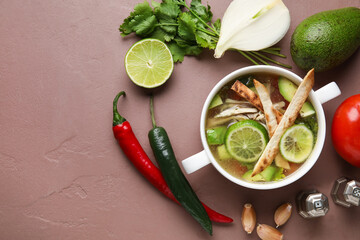 Composition with tasty Sopa de Lima soup on color background