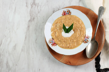 Red and White Porridge (Bubur Merah Putih or Jenang Sengkolo) is a Dish for Welcome the Birth of a Baby in the Javanese. Made from Rice, Sugar, Coconut Milk, Pandan Leaves, and Salt.