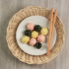 Colorful Songpyeon Kkultteok (Rice Cake with Honey FIlling) in a Wooden Dish. Songpyeon is a Korean Traditional Food Eaten during New Year's Day or Korean Thanks Giving Day.