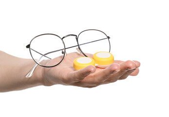 Female hand with contact lenses and eyeglasses on white background