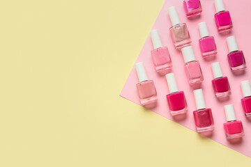 Different nail polishes on color background