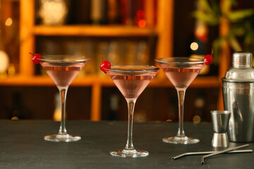 Glasses of tasty cosmopolitan cocktail on table in bar