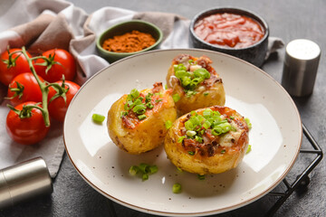 Plate with baked potato on dark background