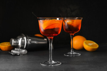 Glasses of tasty aperol spritz cocktail on dark background