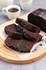 Chocolate Banana Loaf Cake on White Plate, Copy Space for Text, Recipe, and Advertisement.