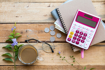 notebook ,cash ,coins and hot coffee of lifestyle woman arrangement flat lay style on background...