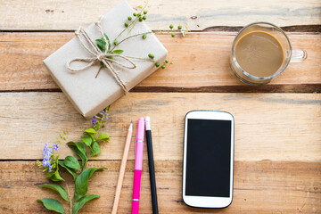 mobile phone with box package prepare send to customer by post office arrangement flat lay style on background wooden