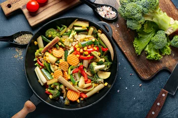 Gordijnen Frying pan with different vegetables on dark background © Pixel-Shot