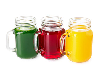 Mason jars with healthy juice on white background