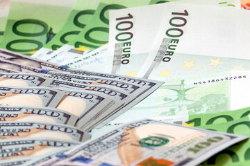 Fototapeta na wymiar banknotes of 100 dollars and 100 euros, close-up
