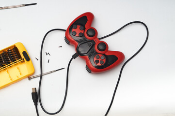 video game control on white background with screwdrivers © Félix Andrés