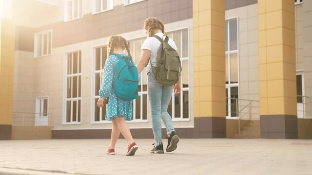 back to school. kids a walk to school for lesson. education training support concept. child walk to school with a backpack. kids rush to school. family day lifestyle. group kids with backpacks