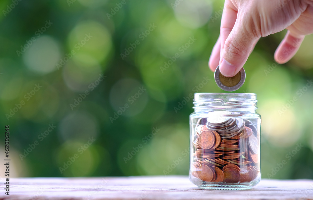 Poster Coins in jar on green background and saving money and business growth concept,finance and investment concept, Growth money of profitability of professional investment.