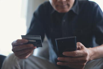 Man using credit card and mobile phone for online shopping and internet payment via mobile banking app