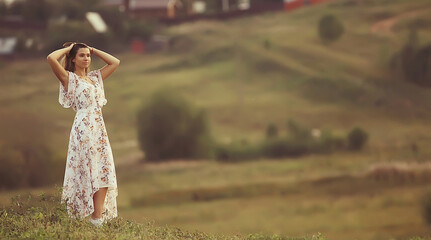 nature summer field portrait girl full growth against the backdrop of a landscape on a summer day