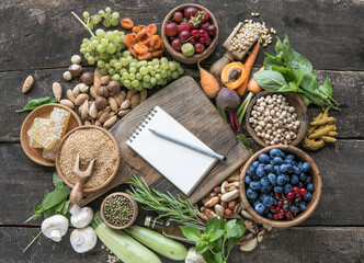 Blank notepad for copy space and  food ingredients on wooden table