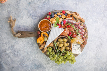 Fototapeta na wymiar Charcuterie board. Cheese platter. Assortment of tasty appetizers or antipasti. Top view. Copy space.