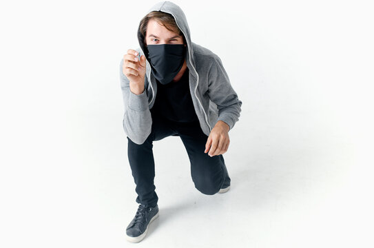 man hiding his face under a mask with a hood anonymity crime theft close-up