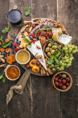 Antipasto background. Different Italian snacks with fruit, nut on a rustic background.