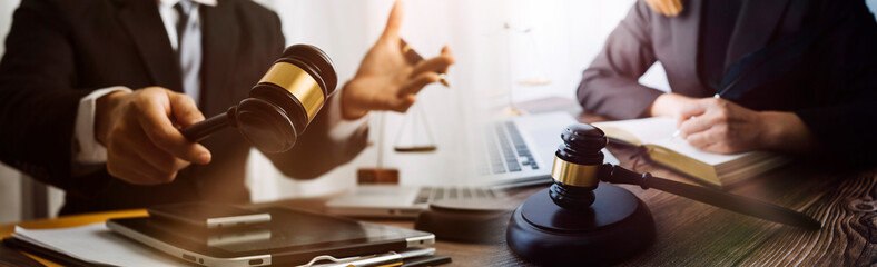 justice and law concept.Male judge in a courtroom on wooden table and Counselor or Male lawyer working in office. Legal law, advice and justice concept.