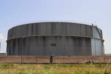 Fototapeta na wymiar Oil storage tanks at the exxonmobil refinery in the Botlek harbor