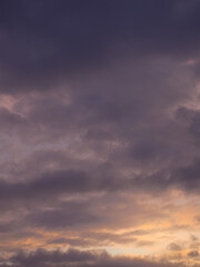 Naklejka na ściany i meble Colored clouds in the sunset sky.