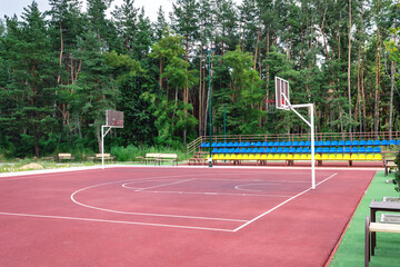 Public basketball court outdoor. An empty sports complex on the outskirts of the city near the...