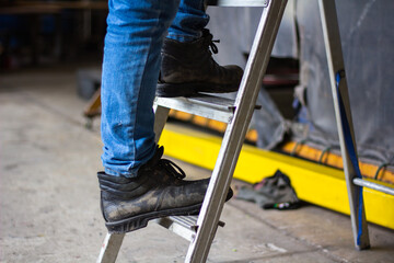 Wear safety shoes to ensure safety at work. construction workers wear safety shoes. concept. Construction workers work on the stairs