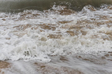 Arabian Ocean waves with foam of blue and turquoise color. Sea foam creating amazing shapes and patterns like glacier. Abstract Arabian Ocean blue water with white wave for background.