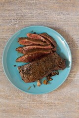 Traditional American cooking grilled steak on a platter, top view