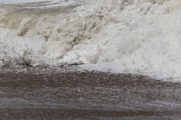 Arabian Ocean waves with foam of blue and turquoise color. Sea foam creating amazing shapes and patterns like glacier. Abstract Arabian Ocean blue water with white wave for background.