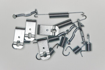 A set of metal components in a heap on the table, parts for car repair. A set of spare parts for...