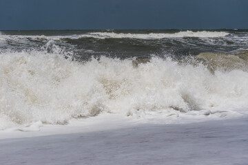 Arabian Ocean waves with foam of blue and turquoise color. Sea foam creating amazing shapes and patterns like glacier. Abstract Arabian Ocean blue water with white wave for background.
