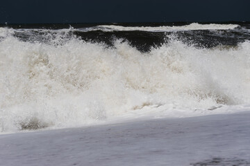 Arabian Ocean waves with foam of blue and turquoise color. Sea foam creating amazing shapes and patterns like glacier. Abstract Arabian Ocean blue water with white wave for background.