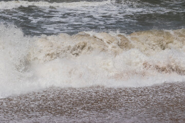 Arabian Ocean waves with foam of blue and turquoise color. Sea foam creating amazing shapes and patterns like glacier. Abstract Arabian Ocean blue water with white wave for background.