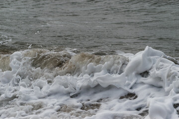 Arabian Ocean waves with foam of blue and turquoise color. Sea foam creating amazing shapes and patterns like glacier. Abstract Arabian Ocean blue water with white wave for background.