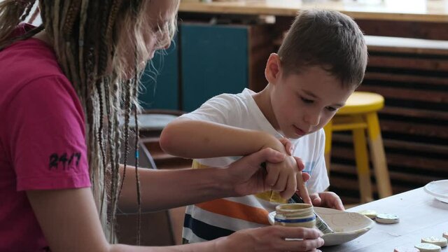 workshop for kids. Children learning how to use clay for making beautiful dishes. Workshop, master class.