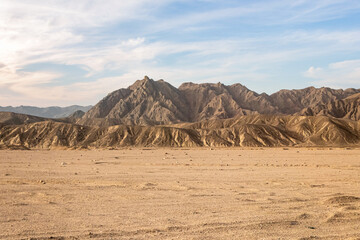 Fototapeta na wymiar Hot desert with mountains with dramatic sky in Egypt, Africa