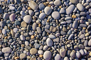 Small pebbles or stone in garden. Texture background. Round oval stones