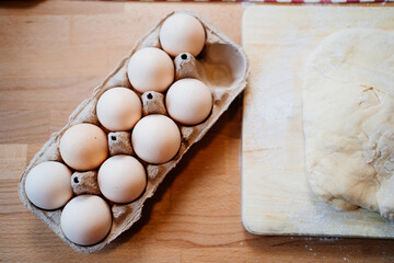 tray with eggs and dough on a wooden table. ingredients for baking. Recipes.