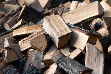 Firewood chopped into pieces. Fireplace fuel. Fireplace heating in winter.