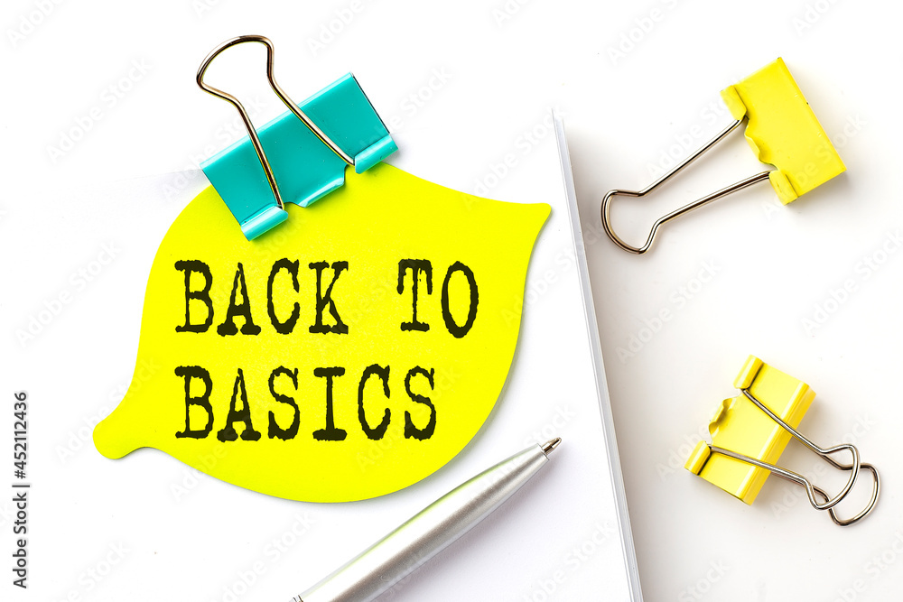 Poster sticker with back to basics text on notebooks on the white background