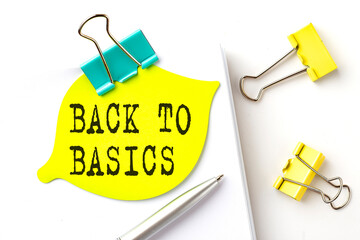 Sticker with BACK TO BASICS text on notebooks on the white background
