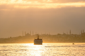Istanbul city lines ferry and cityscape of Istanbul at sunset.