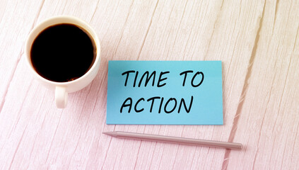 TIME TO ACTION text on the blue sticker with cofee and pen