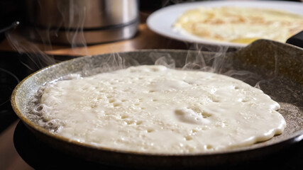 Close up of frying pancake in a pan.